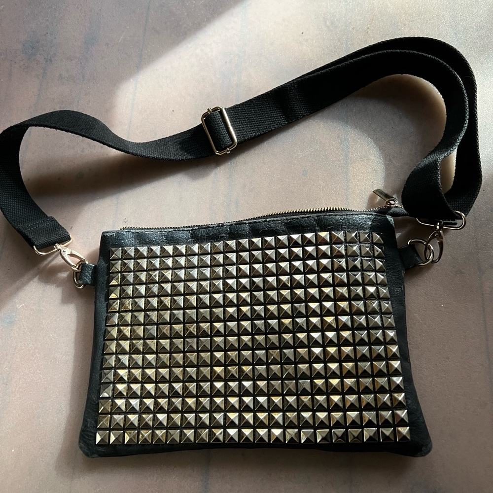Versatile pleather with metal design cross body bag.